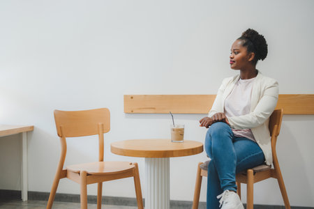 Business woman relaxing in a cafe after a hard days work, drinking a glass of ice coffee. Beautiful young girl.の写真素材