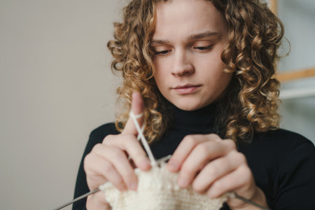 Woman doing knit work with needles to relax and enjoy time at home. Hand made work relaxation therapy. Alternative lifestyle conceptの写真素材