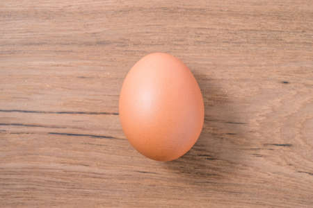 Close up Single Egg on wooden background, isolated, fresh eggの写真素材