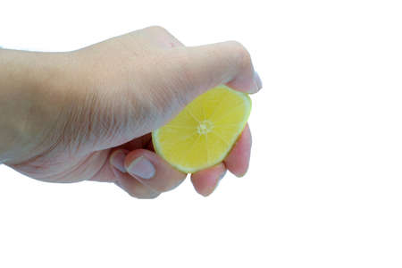 Asian's hand squeezing cutted lemon isolated on white background with Clipping pathの写真素材