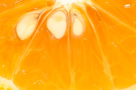 Super close-up orange texture with some seeds. Abstract background.の写真素材