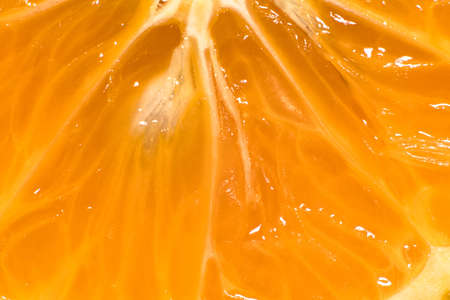 Super close-up orange texture with some seeds. Abstract background.