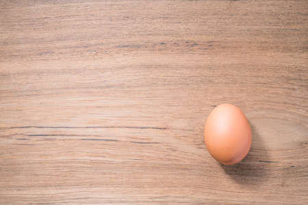 Close up Single Egg on wooden background, isolated, fresh eggの写真素材