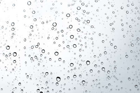 Abstract background. Water drop on the clear umbrella. Green and white bokeh backgroundの写真素材
