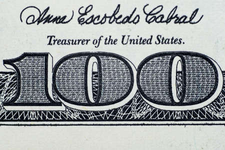 Close up on US dollar banknotes. Number 100 on US Dollar banknotes. Shooting by 1:1 Macro lense.の写真素材