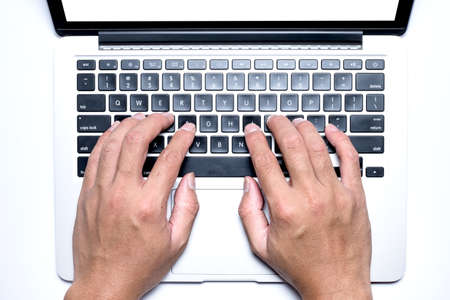 Top view, Male's hand working by using and typing on white laptop with blank white screen. Isolated on white background with clipping path.の写真素材