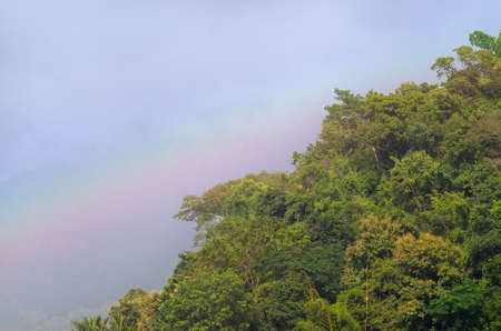 Beautiful scene of rainbows over green mountain with blue sky in Autumn.の写真素材