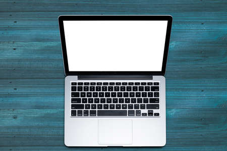 Top view, Working desk, computer, laptop, smart phone, coffee mug, glasses and notebooks on wooden blue  pastel color with texture background with copyspace for text clipping path.の写真素材