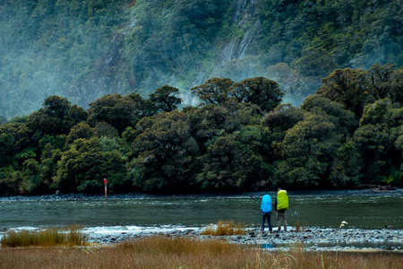 A couple backpacker enjoy with the stunning scene of the green nature and ford land at Milford...