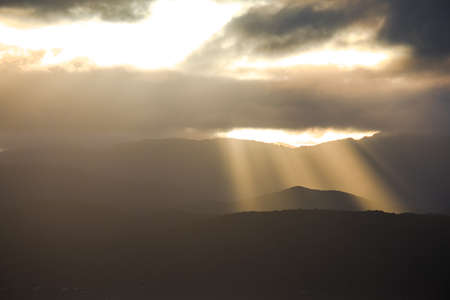 Stunning landscape sunrise  in the morning. Golden light go through the cloud to the mountain and...