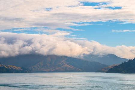 Landscape of the Mountain and sea with cloudy in the morning. View from the ferry to  South Island,...