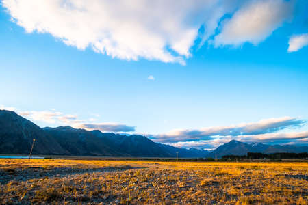 Beautiful scene of the yellow grassland mt cook and lake tekapo before sunset.の写真素材