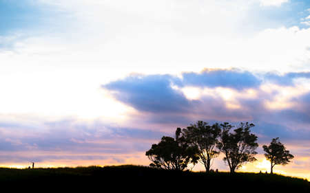 Silhouette scene of a couple enjoy with their drone at sunset on the top of Mt. Eden, Auckland, New Zealand.の写真素材
