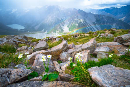 Stunning view on the high mountain after the rain with colorful rainbow over the rocky mountain and glacier in Mt Cook National parkの写真素材
