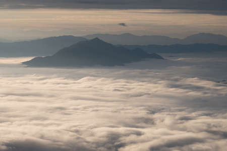 Beautiful sunrise scene at high mountain with yellow clouds and blue sky, Phu chi fah Chiangrai Thailandの写真素材