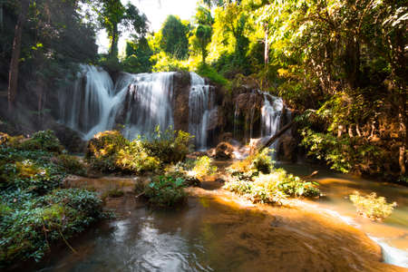 Than sawan Waterfall, Payao, Thailand, Long explosure shot, Beautiful green waterfall in the nature at sunset.の写真素材