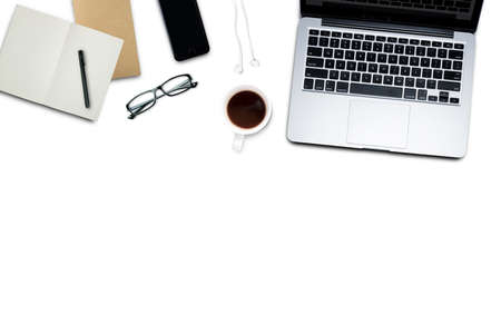 Top view, Working desk, computer, laptop, smart phone, coffee mug, glasses and notebooks on pastel color background with copyspace for text.の写真素材