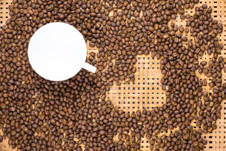 Flay lay style, Medium dark Roasted peaberry coffee beans with empty coffee cup on bamboo handcraft...