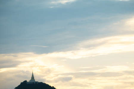 Beautiful silhouette shot of golden pagoda and the temple on the high mountain at sunset.の写真素材