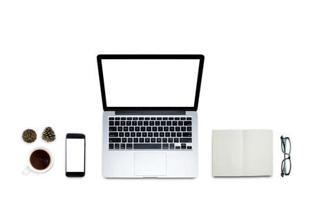 Top view, Working desk, computer, laptop with blank screen, smart phone, coffee, mug, glasses, Pine cones and notebooks on white background with copyspace for text and clipping path.の写真素材