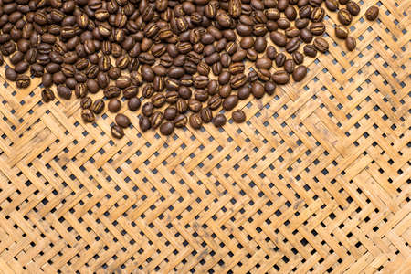 Flay lay style, Medium dark Roasted peaberry coffee beans on bamboo handcraft background with copy space. の写真素材