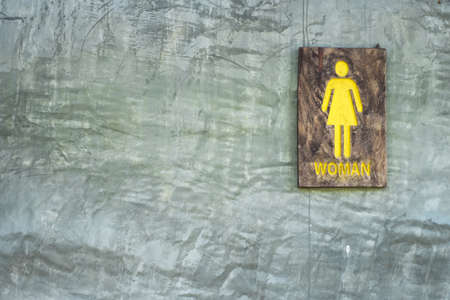Toilet sign, symbol, made by old wooden paint by yellow color.の写真素材