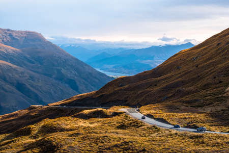 The beautiful road between Queenstown and Wanaka via Crown range. Grassland and beautiful landscape of rocky mountains.の写真素材