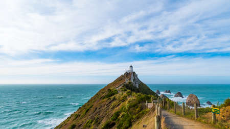 Nugget Point, Rocks cliffs, and beautiful ocean. A path to Lighthouse. The Catlins, New Zealand.