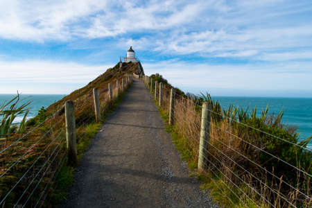 Nugget Point, Rocks cliffs, and beautiful ocean. A path to Lighthouse. The Catlins, New Zealand.