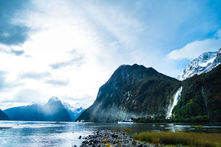 A stunning scene of nature with snow mountain and ford land at Milford Sound, New Zealand.の写真素材