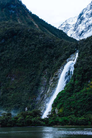 A stunning scene of nature with snow mountain and ford land at Milford Sound, New Zealand.の写真素材