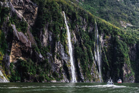 A stunning scene of nature with many waterfalls from the high mountain at Milford Sound, New Zealand.のeditorial素材