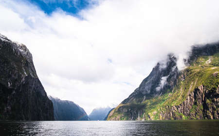 A stunning scene of nature with snow mountain and waterfalls at Milford Sound, New Zealand.の写真素材