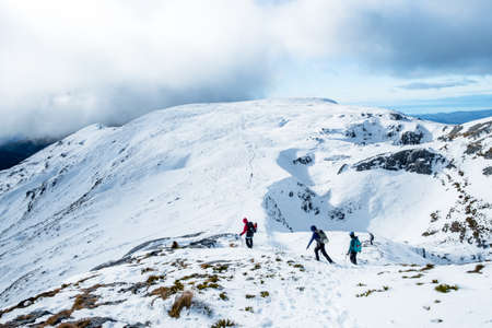 People hiking on the beautiful snow mountains. kahurangi national park, New Zealand.