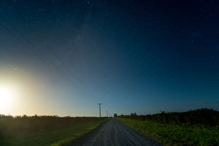 Beautiful night scape in the rural area. Moon light and starry night.の写真素材