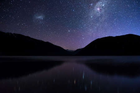Amazing Starry night at Lake Rotoiti. Reflection of the Milky way and galaxy on the lake. Nelson Lake National Park, New Zealand.の写真素材