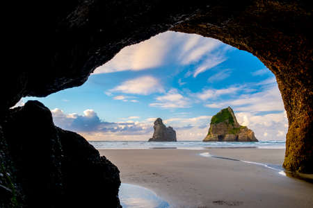 The beautiful Wharariki Beach with famous rocks. Sunset scene golden light and silhouette. Nelson, South Island, New Zealand.の写真素材
