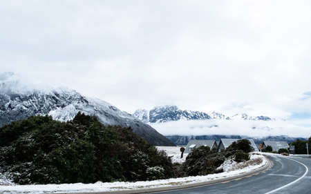 View of a road in Mount Cook Village covered with white fresh snow after a snowy day.の写真素材
