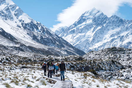 2018, Oct 13 - New Zealand, Mount Cook Natioanl Park, People walking on the boardwalk in Hooker Valley track. Winter snow after a snowy day.のeditorial素材