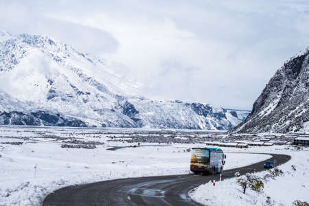 2018, Oct 12 - New Zealand, Mount Cook Village, View of a road in covered with white fresh snow after a snowy day.のeditorial素材