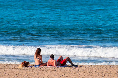 A couple are enjoying with the sun and a sea on the beach..の写真素材