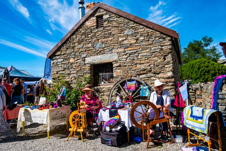 2019 FEB 12, New Zealand, Cromwell, A lady using the old traditional wooden yarn machine in market..