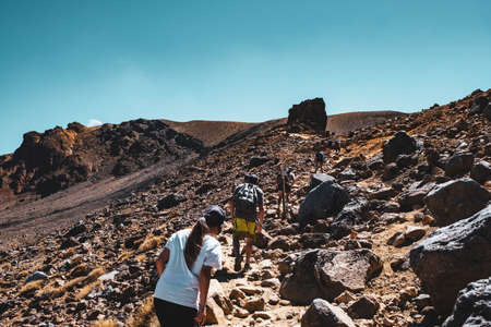 New Zealand, North Island, A group of people trekking in Beautiful Landscape of Tongariro Crossing track on a beautiful day..の写真素材