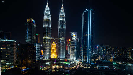 2019 May 10th, Malaysia, Kuala Lumpur - view of the Petronas twin towers and other buildings in the city at night.のeditorial素材
