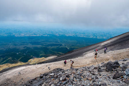 People are hiking on the volcano mountain. Summit track, Mount Taranaki, New Zealand.のeditorial素材