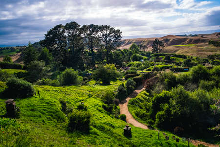 2019, February 18th, New Zealand, Matamata, Hobbiton movie set - Beautiful scenery of the garden and hobbit house (hole) in Shire.のeditorial素材