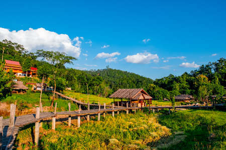 Stunning scenic landscape of the famous Boon Ko Ku So (Kho-Ku-So) bamboo bridge at Pai, Mae Hong Son, Thailand. Rice field season and sunset scene.の写真素材