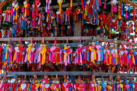 2019, November 21st, Pai, Mae hong son, Thailand. A lot of Chinese style amulets hanging on the wooden shrine. use for making wishes for love and life.のeditorial素材