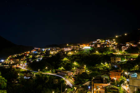 A night Landscape panorama view of ocean mountain and Jiufen village light.の写真素材