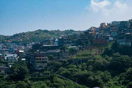 landscape view of JiuFen Village with mountain residental buildings and blue sky. Ruifang District, New Taipei City, Taiwanのeditorial素材
